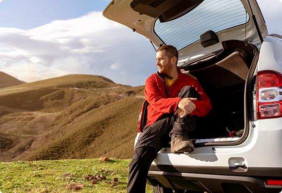 a man sitting in the trunk of a car