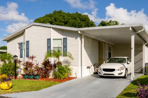 a white car parked in front of a house