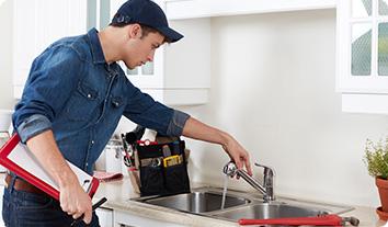 a man washing his hands in the sink