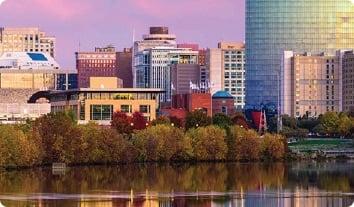 a body of water with trees and buildings around it