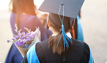 a woman wearing a graduation cap and gown