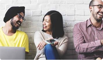 a group of people looking at a laptop