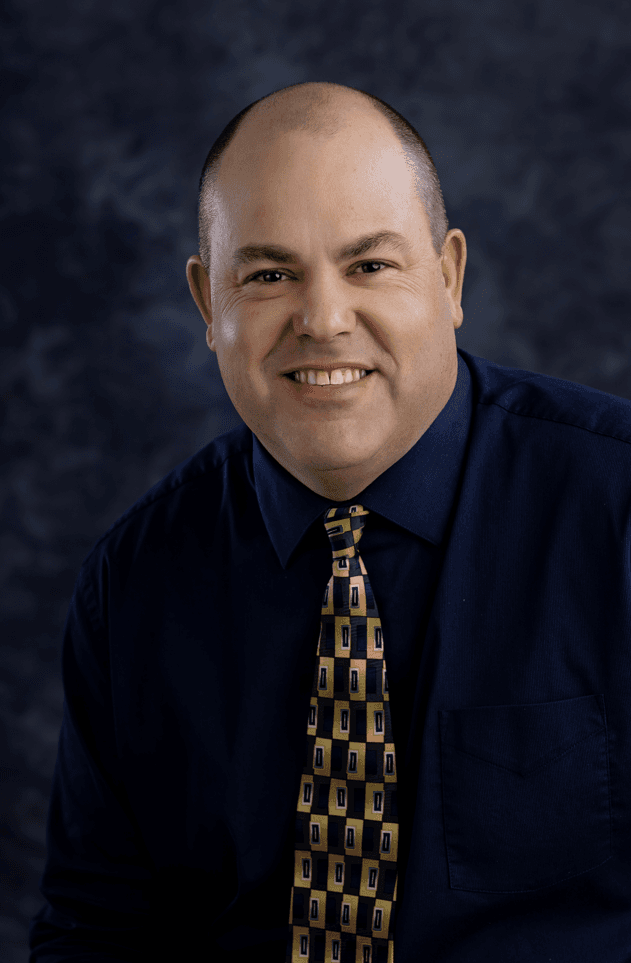 a man in a tie smiling