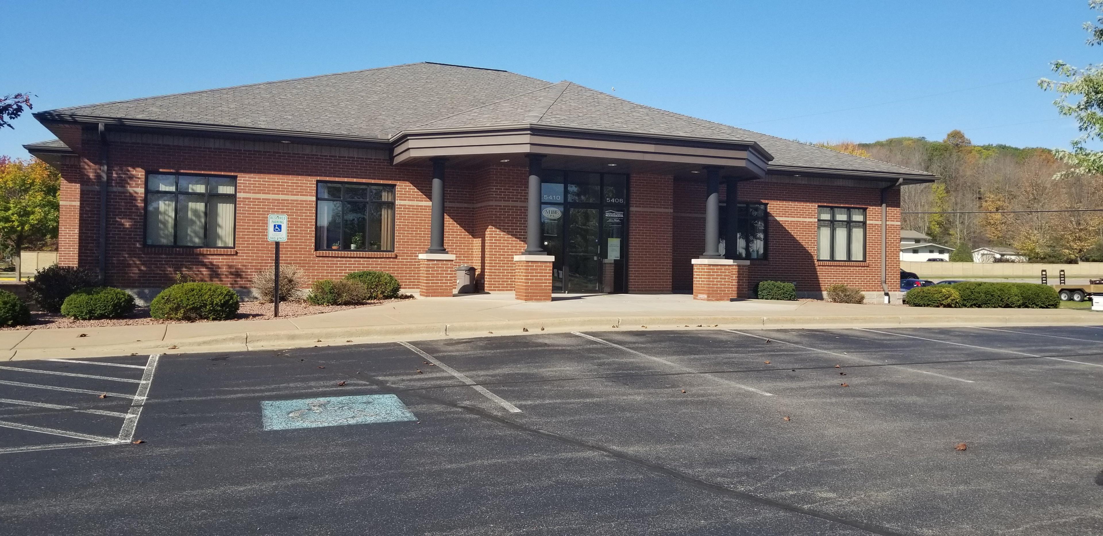 a brick building with a parking lot