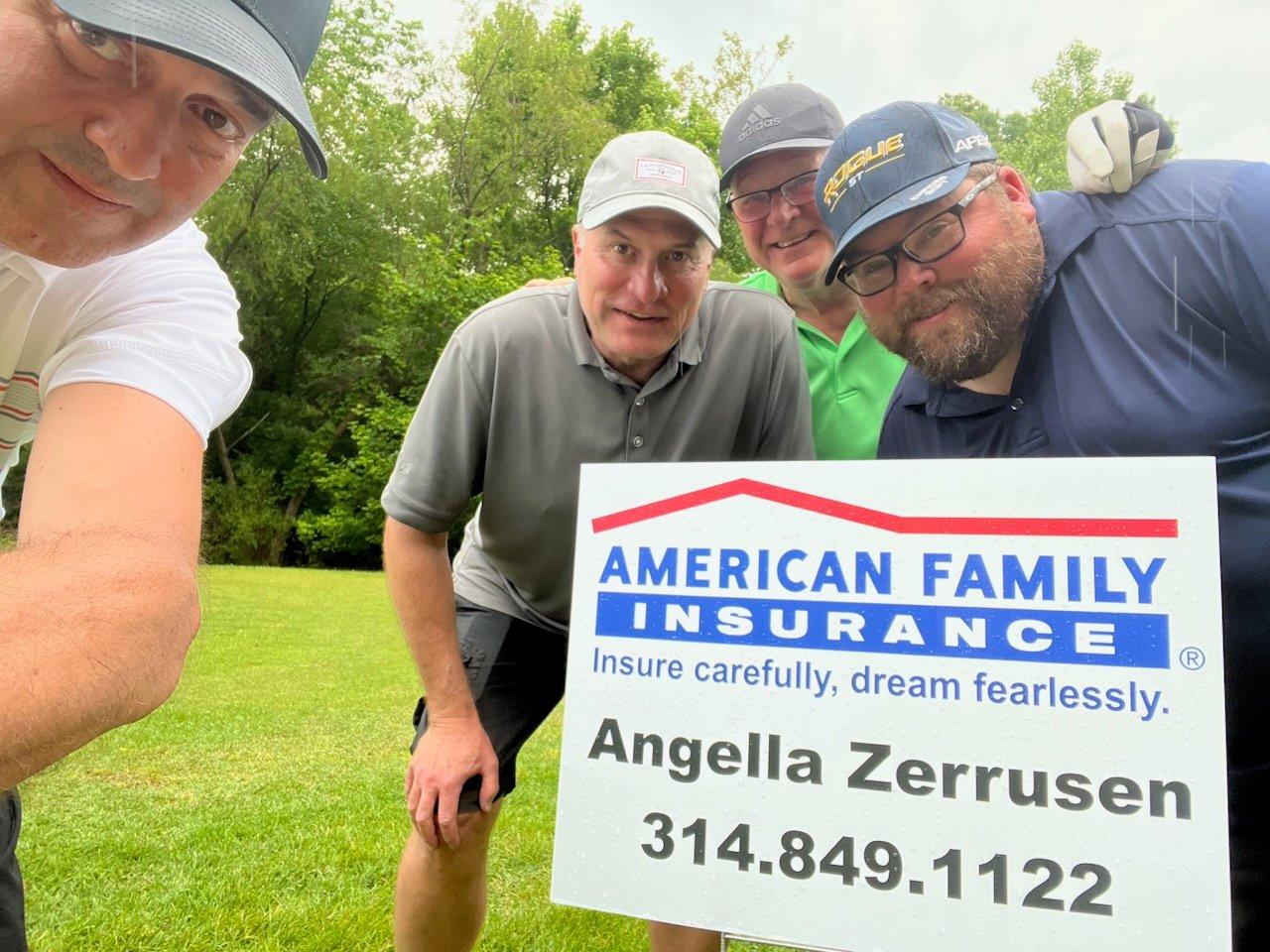 a group of men holding a sign