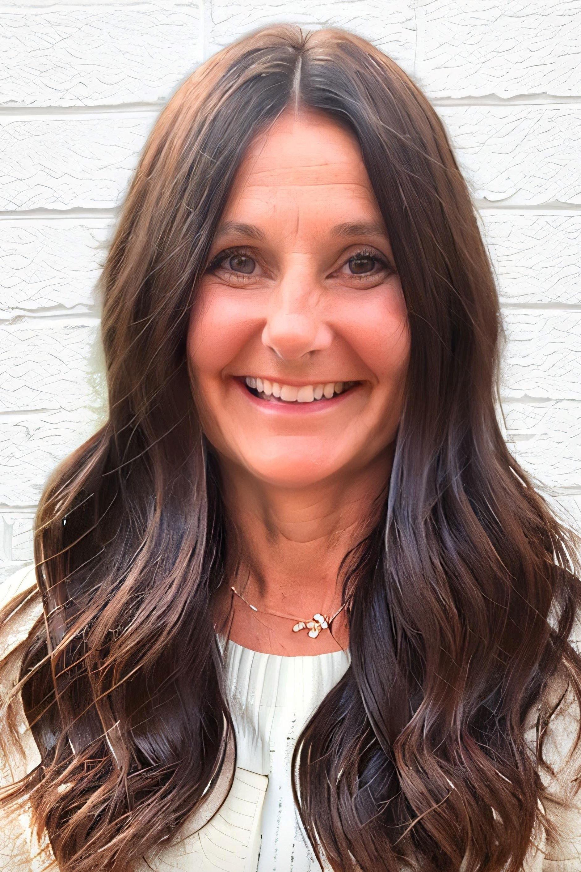 a woman with long hair smiling