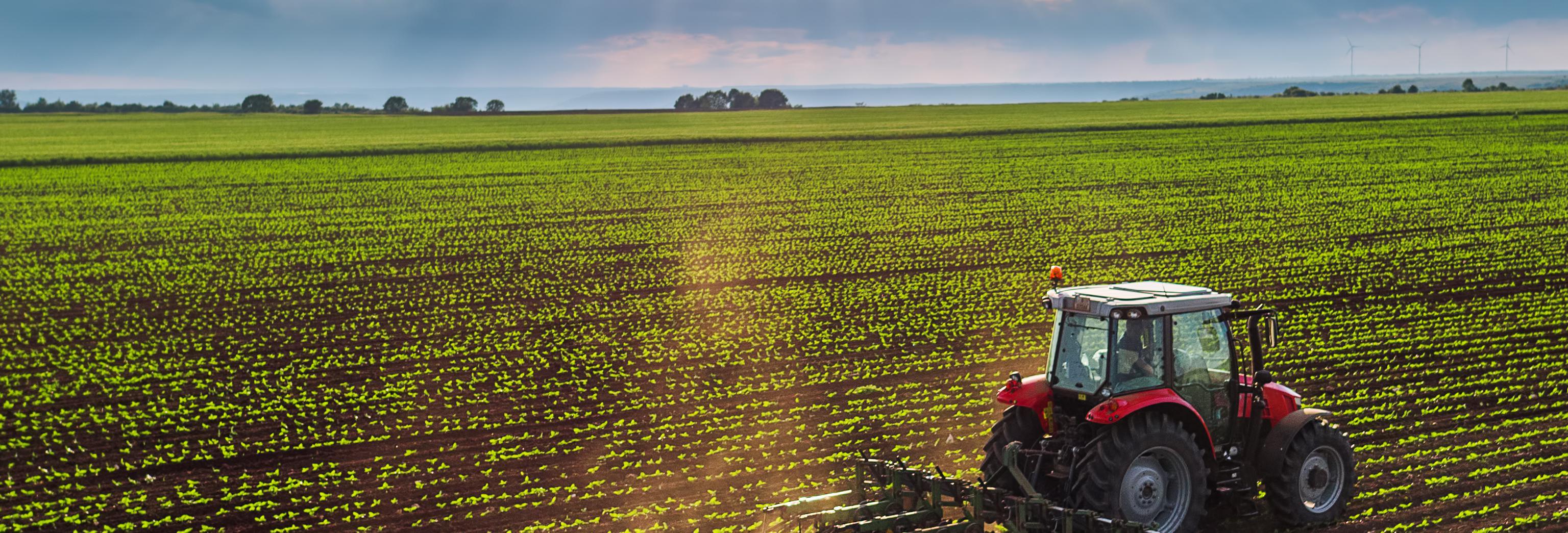 a tractor planting in a farm field