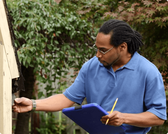 An insurance agent inspecting a home's roof damage.