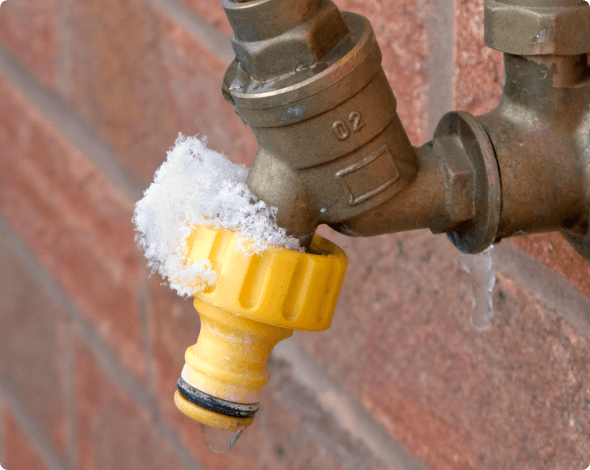 a frozen outdoor water spigot