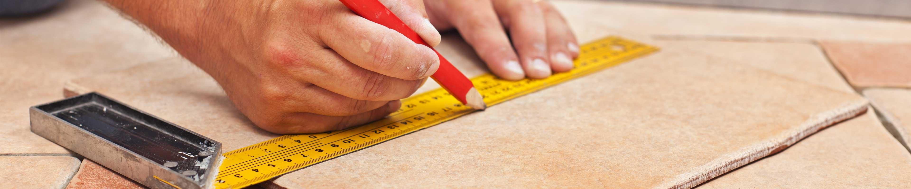 Man measuring floor tiles