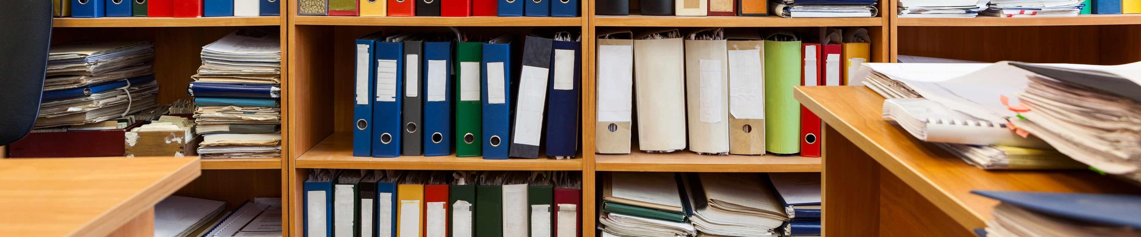 Binders on book shelf with patents, trademarks and copyright for intellectual property.