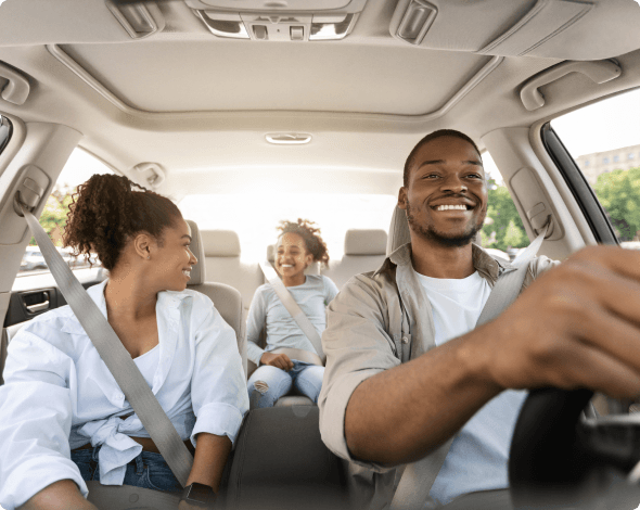 Parents and child in a car on the road