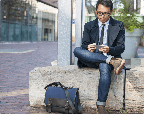 a man sitting and looking at his phone