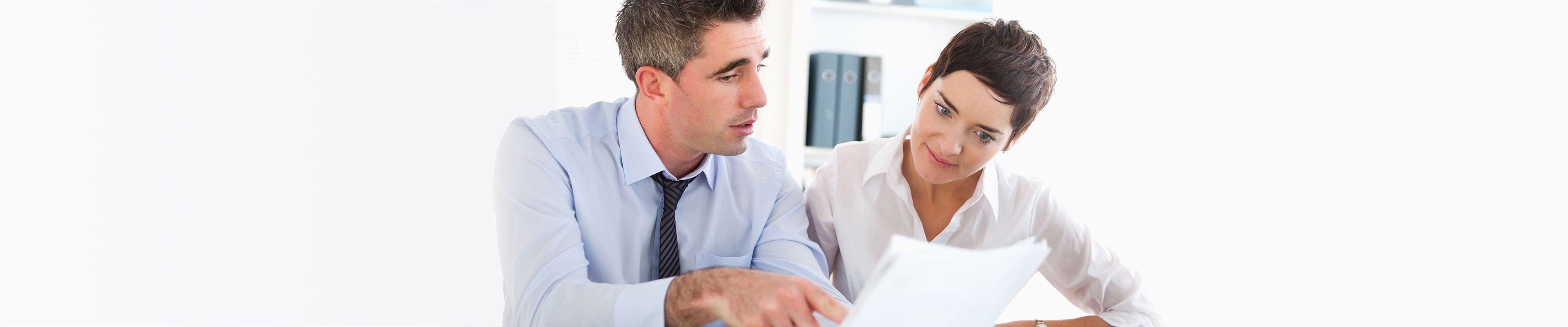 Image of a landlord reviewing a credit history report with a prospective tenant.