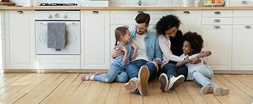 a group of kids sitting on the floor in front of a stove