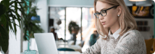 a woman reading on a laptop