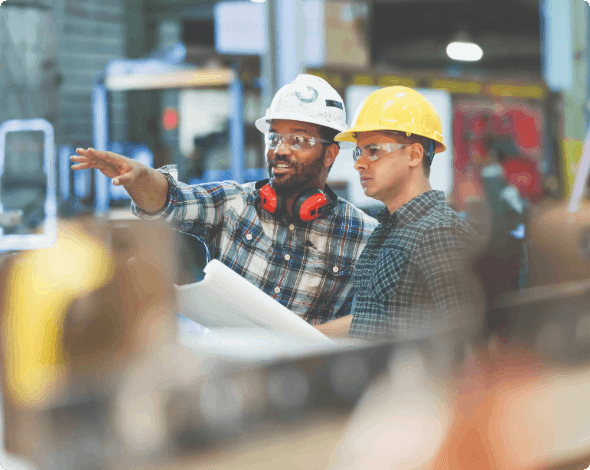 Two workers meeting in a factory.