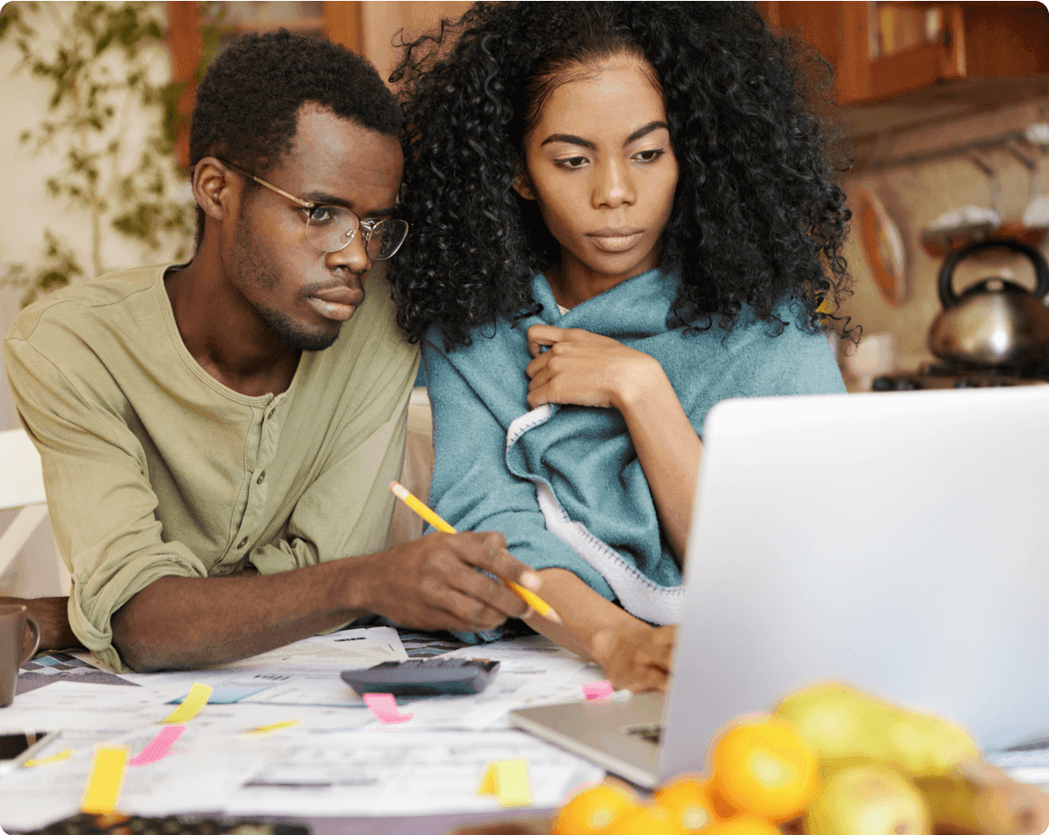 a man and a woman looking at a laptop